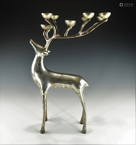 A HEAVY SILVER COLORED DEAR CANDLE HOLDER