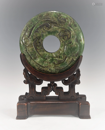 A LARGE CHINESE DARK GREEN SPINACH JADE BI DISK