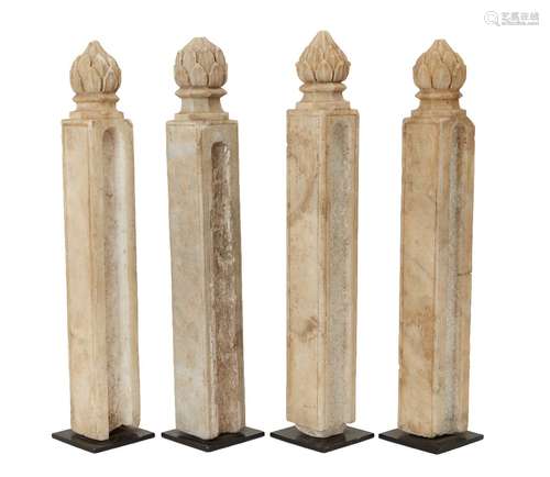 Four Mughal columnar shaped carved marble posts with finials...