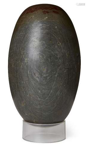 A polished lingham stone, of typical ovoid form, 34cm. long ...