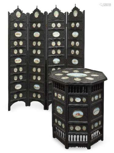 A finely carved ebony four-fold screen and occasional table,...