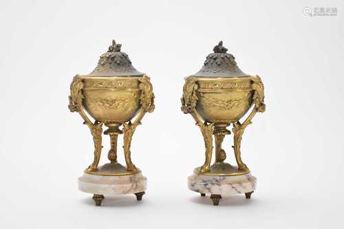 A pair of gilt metal and white veined marble urns and covers...