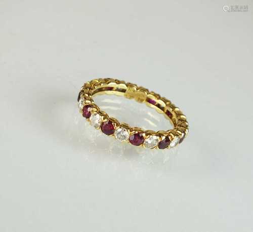 An 18ct gold ruby and diamond full eternity ring by Bouchero...