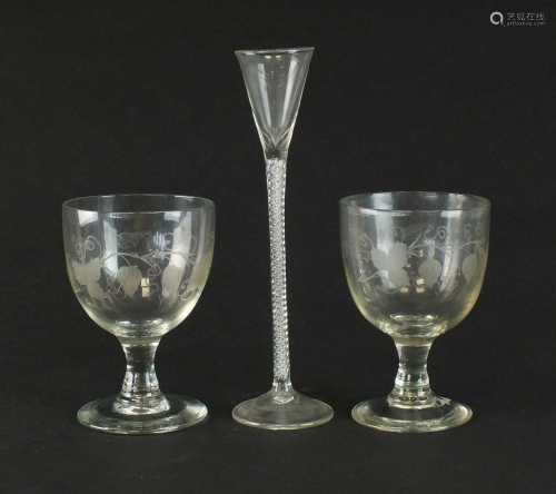 A pair of 19th century engraved glass goblets and an air-twi...