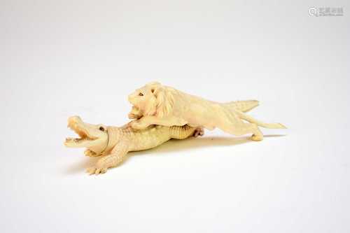 A Japanese ivory okimono of a crocodile attacked by a lion