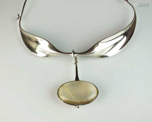 A Georg Jensen silver neck ring and rutilated quartz pendant...