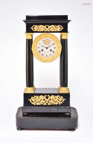 A 19th century ebonised and gilt metal mounted portico clock