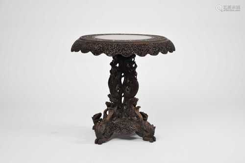 A Burmese carved hardwood tilt-top table