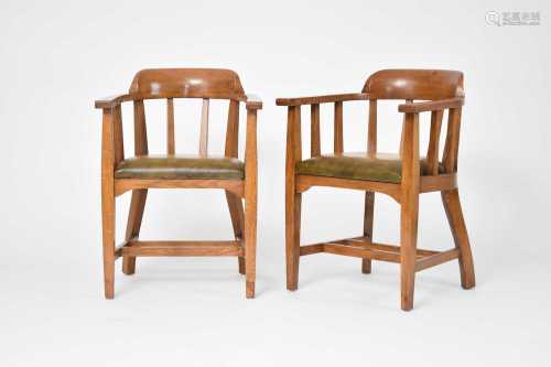 A pair of Arts and Crafts style oak elbow chairs