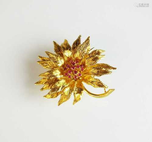 An 18ct gold ruby set flower brooch