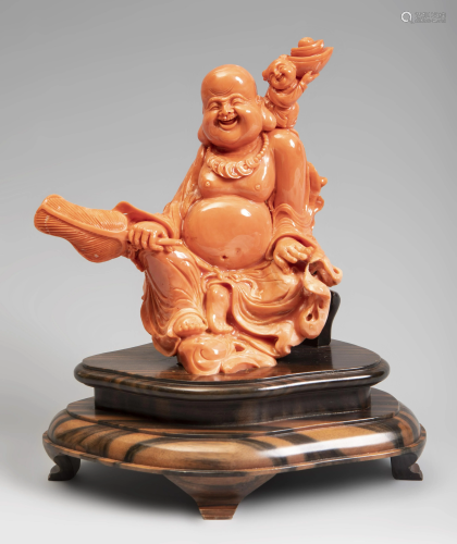 Smiling Buddha. China, 20th century. Coral. Wood