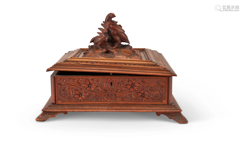 A 'BLACK FOREST' CARVED AND STAINED WOOD CASKET