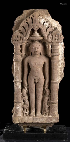 A STONE NICHE WITH TIRTHANKARA AND ATTENDANTS N…