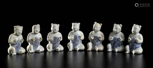 SEVEN GLAZED PORCELAIN SEATED CHILDREN China, Qing