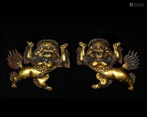 OLD TIBETAN,A PAIR OF GILT-BRONZE LION PANELS