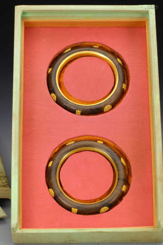 PAIR OF CHENXIANG WOOD WITH GILT DECORATED BANGLES