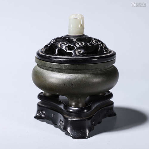 A three-legged red sandalwood jade-inlaid copper incense bur...