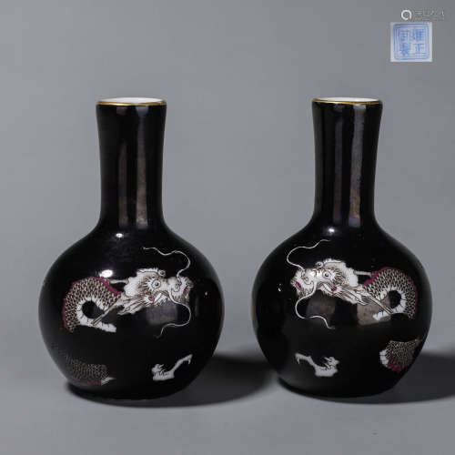 A pair of black glazed cloud and dragon porcelain vases