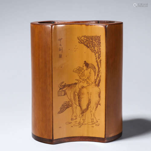 A carved bamboo brush pot