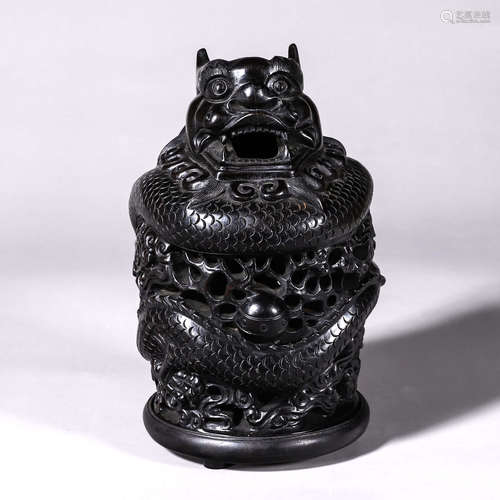 A hollowed out red sandalwood incense burner