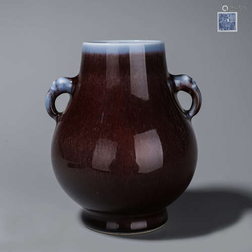 A deep red glazed porcelain zun with elephant head-shaped ea...