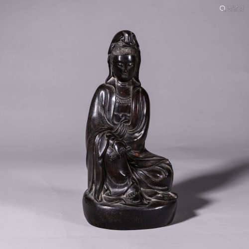 A red sandalwood carved Guanyin statuette