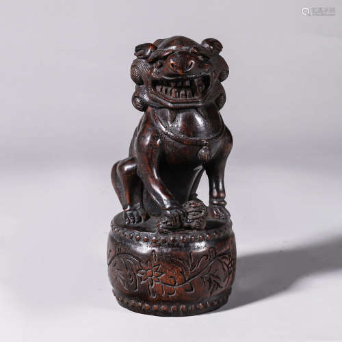 An aloeswood carved lion ornament