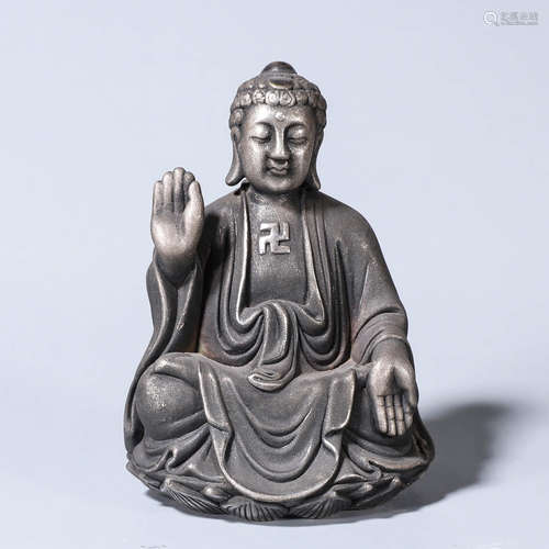 A silver Mahavairocana buddha statue