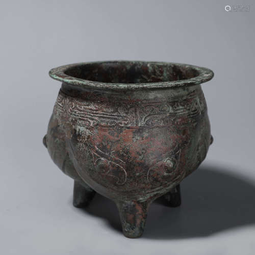 A dragon patterned three-legged bronze pot