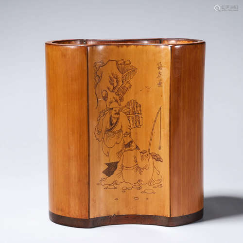 A carved bamboo brush pot