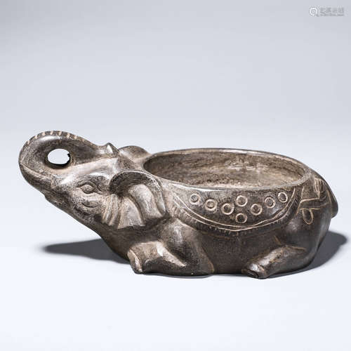 A stone carved elephant shaped brush washer