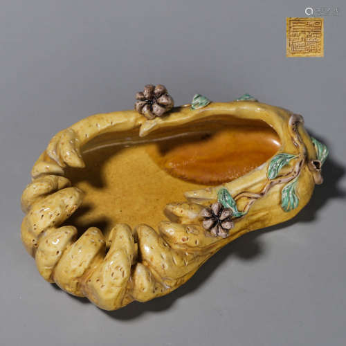A yellow glazed porcelain buddha hand shaped water pot