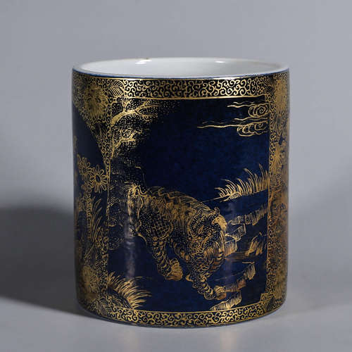 A blue glaze gilt beast and plant porcelain brush pot