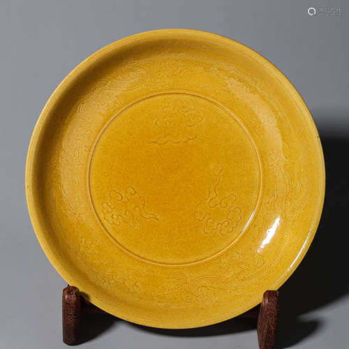 A yellow glazed cloud and dragon carved porcelain plate