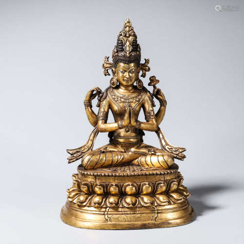 A gilding copper four-armed Guanyin statue