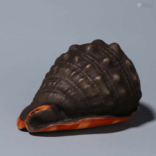 A porcelain snail ornament