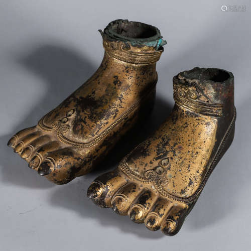 A pair of gilt copper buddha feet