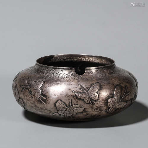 A flower and butterfly patterned silver water pot