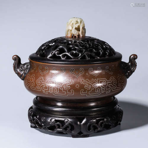 A dragon patterned jade-inlaid copper incense burner with el...