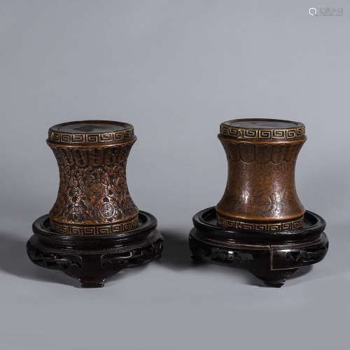 A pair of copper spindle heads