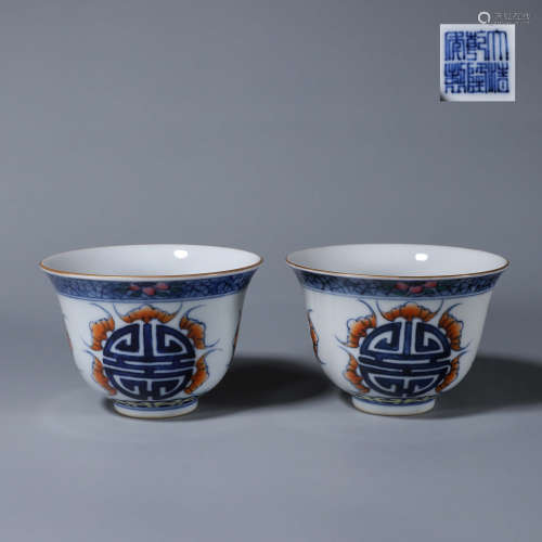 A pair of doucai bat inscribed porcelain cups
