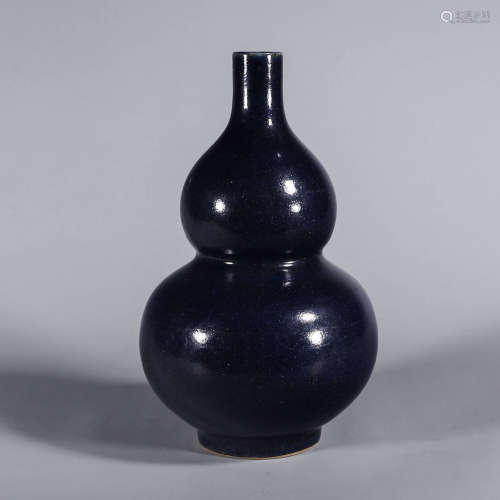 A deep blue glazed porcelain gourd-shaped vase