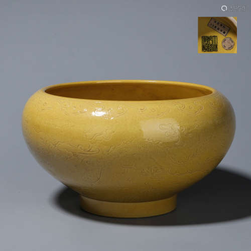 A yellow glazed dragon carved porcelain brush pot