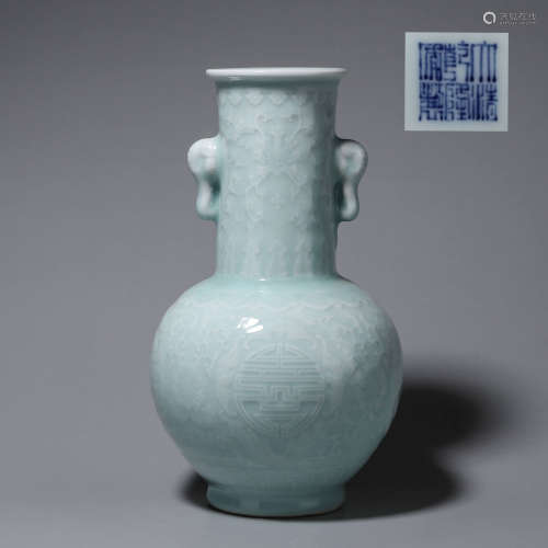 A celadon glazed porcelain vase with elephant head-shaped ea...