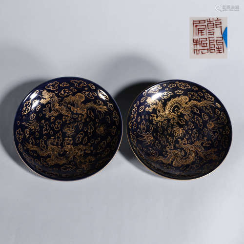 A pair of blue glazed gilt cloud and dragon porcelain plates
