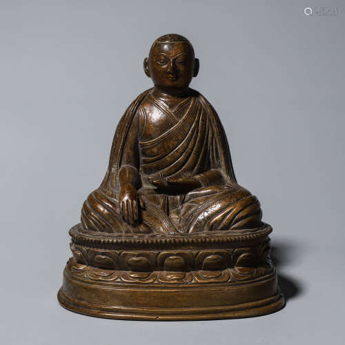 A copper sitting buddha statue