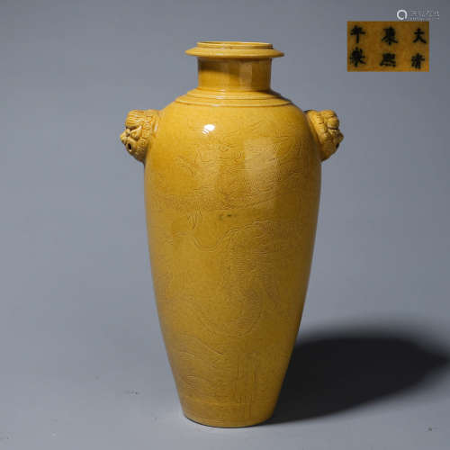 A yellow glazed dragon carved porcelain vase with lion head-...