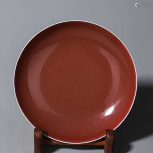 A deep red glazed porcelain plate