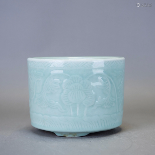 A CARVED CELADON TRIPOD CENSER