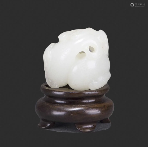 A WHITE JADE CARVING WITH STAND